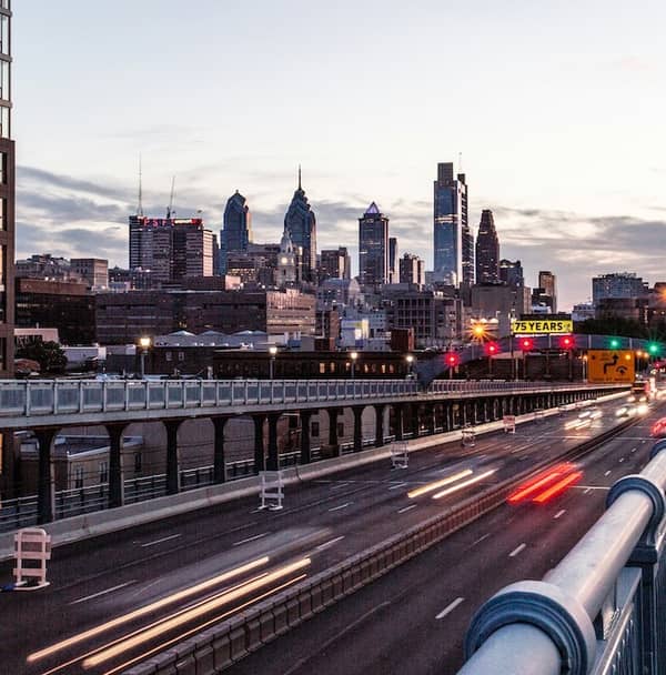 The Philadelphia skyline at dusk, seen across the expressway from the South Street bridge
