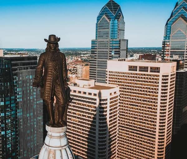 The William Penn statue on top of Philadelphia City Hall, with the Center City skyline behind it